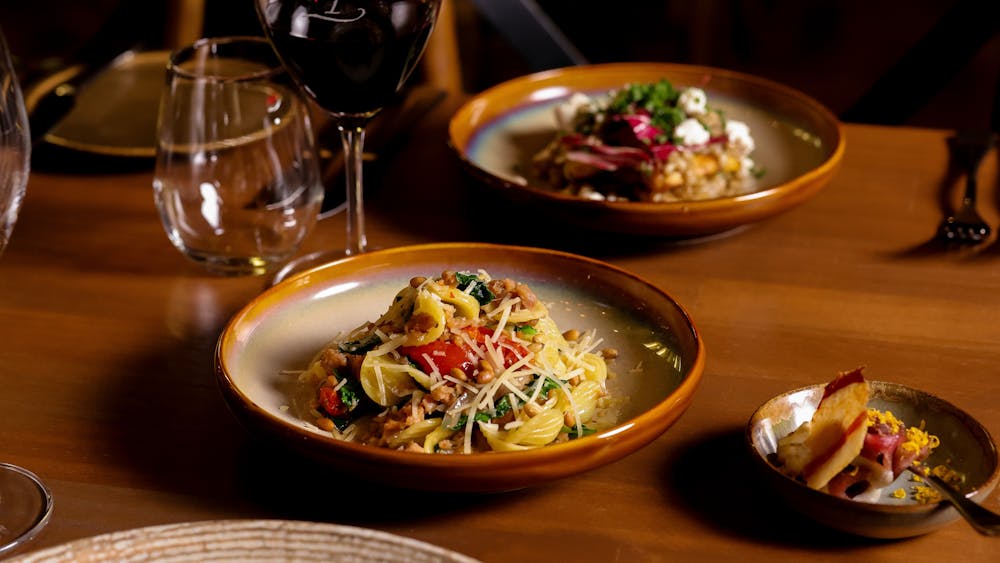 Dishes served with wine glasses at Peasant Osteria