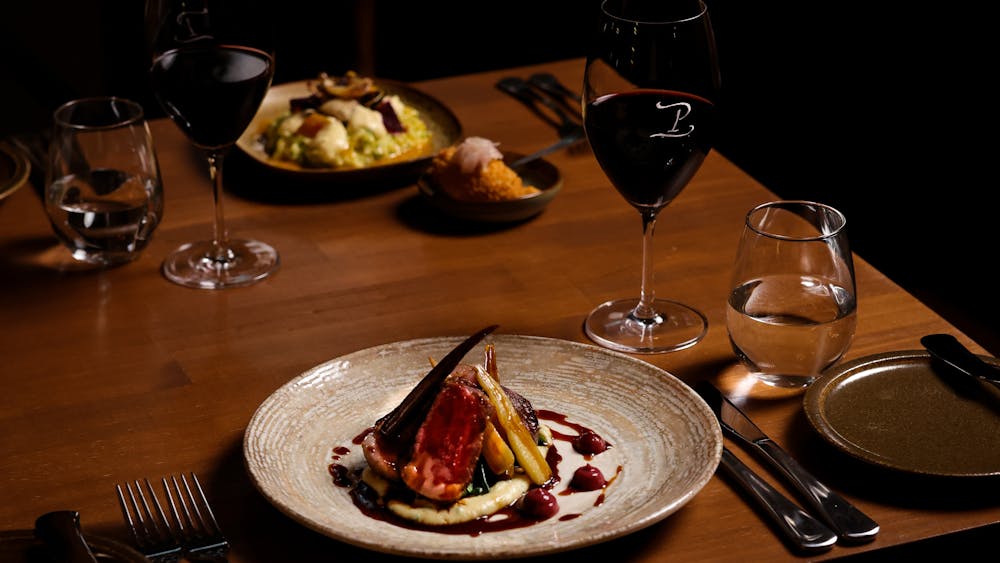 Dishes served with wine glasses at Peasant Osteria
